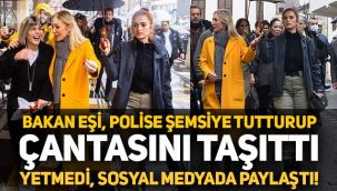Kültür ve Turizm Bakanı'nın eşi Pervin Ersoy, polis memuruna şemsiye tutturup çantasını taşıttı