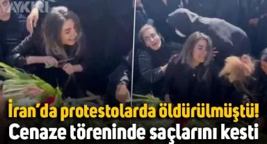 İran'da protestolarda öldürülen Hadis Najafi'nin ablası cenazede saçlarını kesti