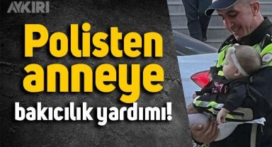 Hatay'da bir polis memurunun aracını park alanından çıkaramayan annenin bebeğine baktığı anlar