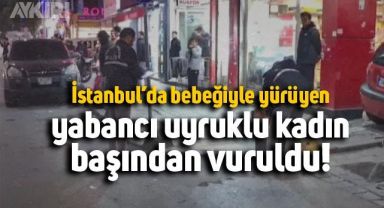 Sultanbeyli'de kucağındaki bebeğiyle yürüyen yabancı uyruklu kadın...