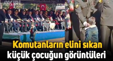 Törende komutanların elini sıkan küçük çocuğun görüntüleri