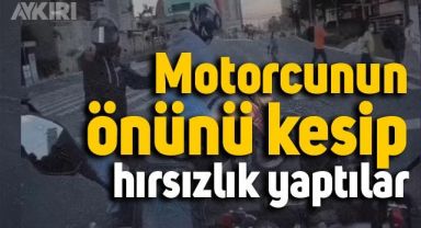 İşlek caddede motorcunun önünü kesip hırsızlık yaptılar